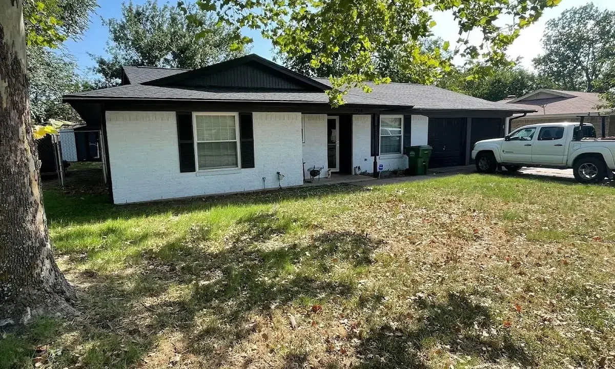 Professional roofing crew working on a residential roof in Hazelwood